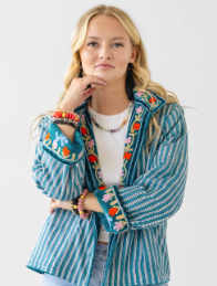 woman wearing printed reversible jacket in teal