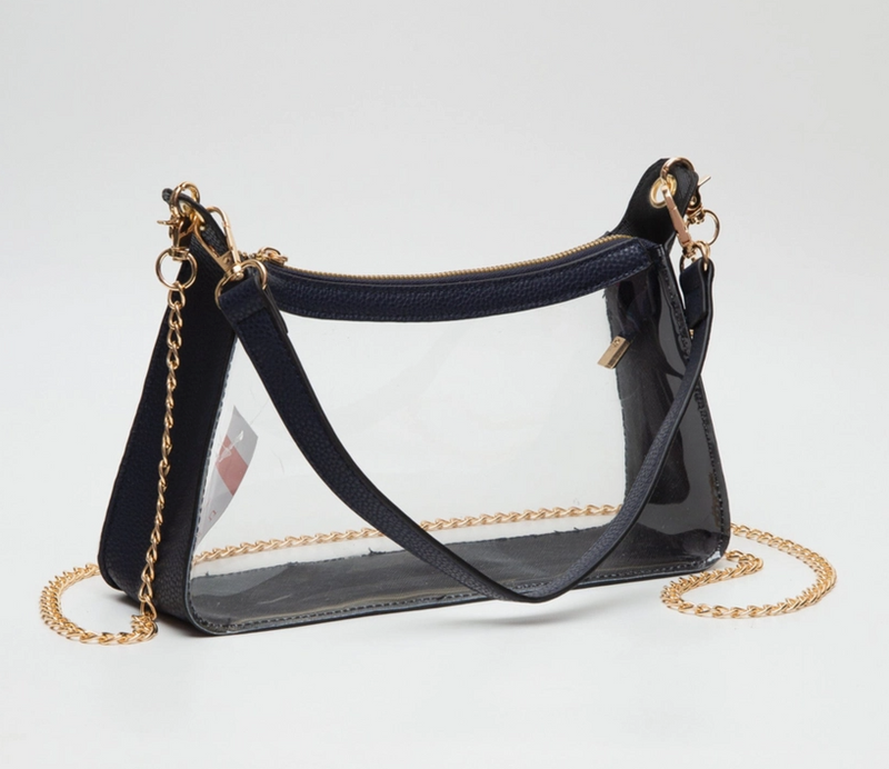 Black handbag with clear section and gold chain strap on a white background
