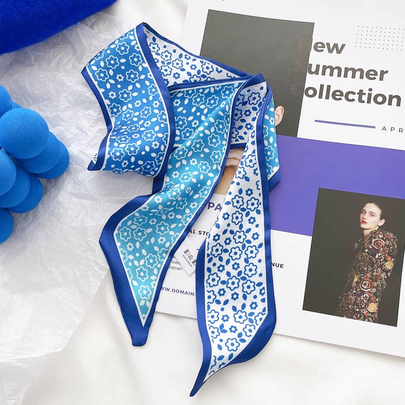 Blue floral patterned scarf on a magazine with fashion-themed cover