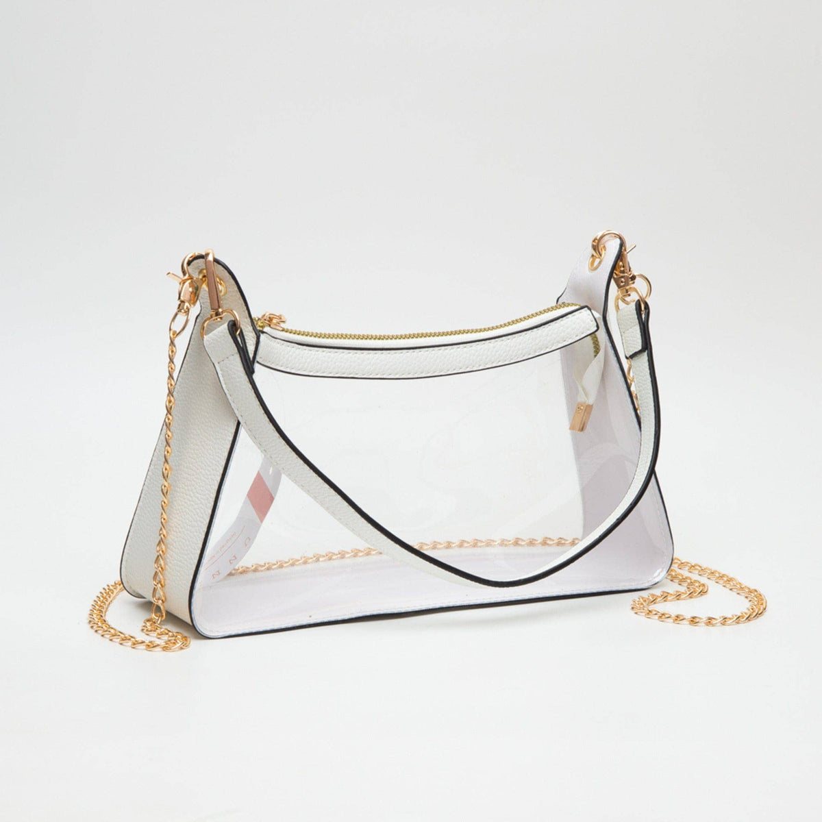 Clear handbag with gold chain strap on a white background