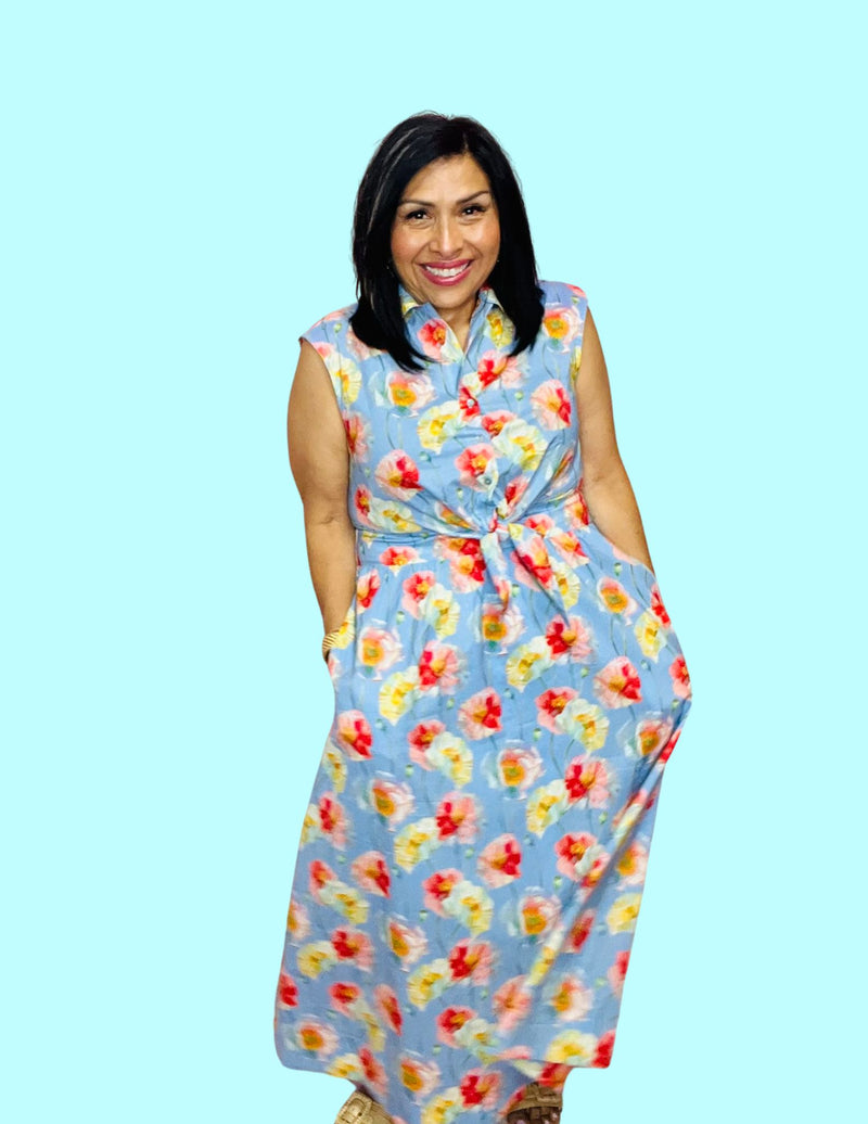 Woman wearing a floral dress against a light blue background