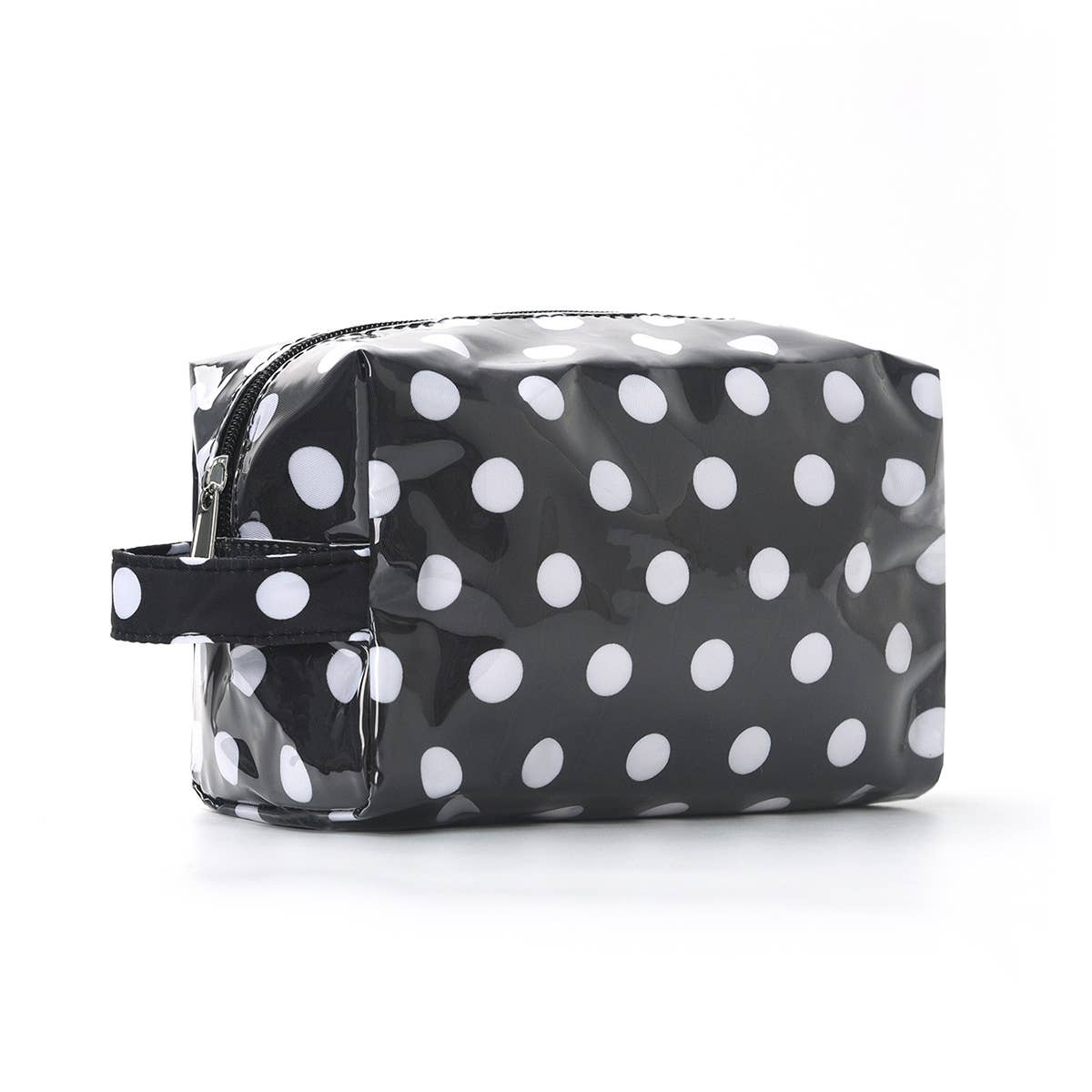 Black toiletry bag with white polka dots on a white background
