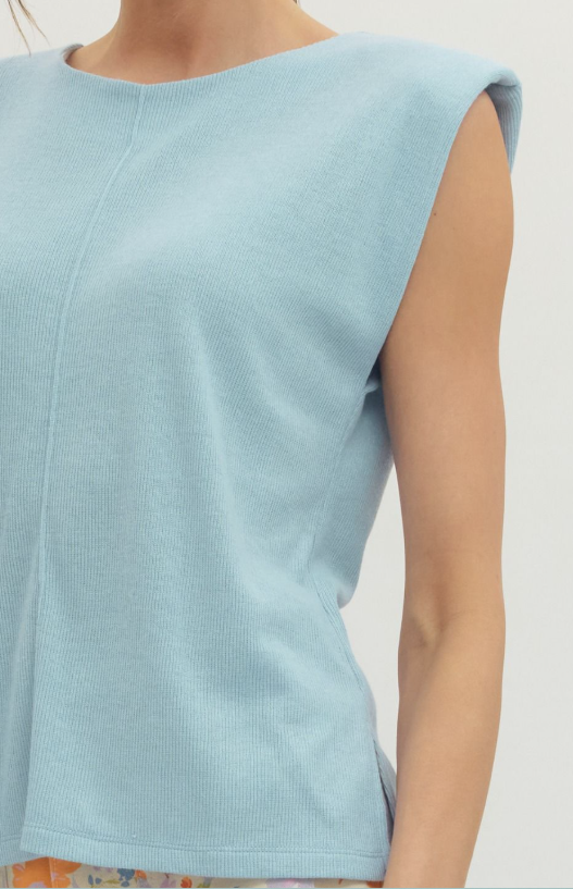 Light blue sleeveless top worn by a person on a plain background